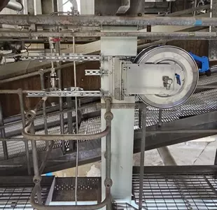 High-pressure stainless steel hose reel and trigger gun mounted to a support column as part of the washdown system at an industrial site in Burton.